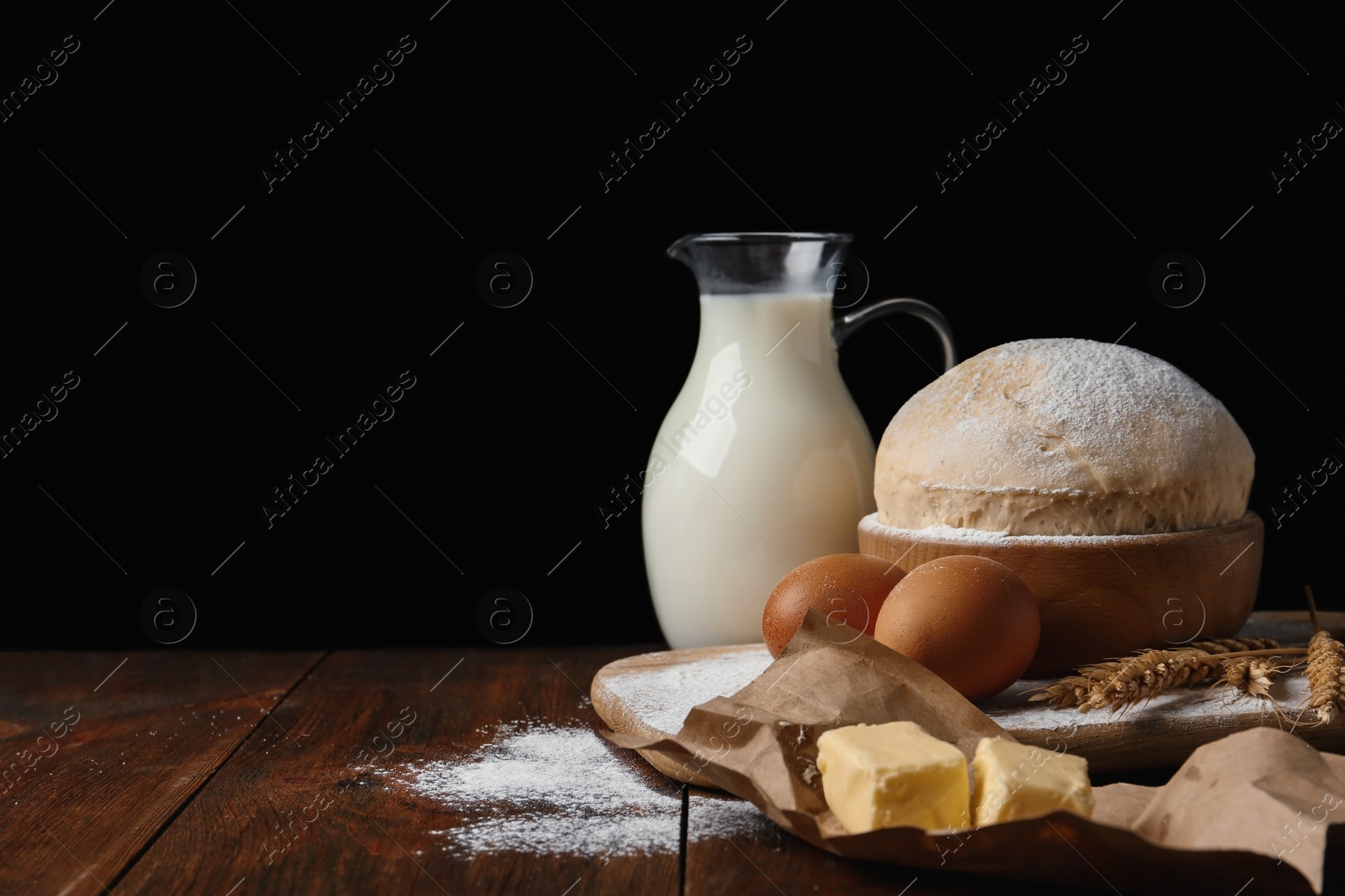 Photo of Raw eggs and other ingredients on wooden table. Baking pie