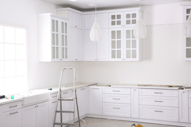 Photo of Renovated kitchen interior with stylish furniture and maintenance equipment