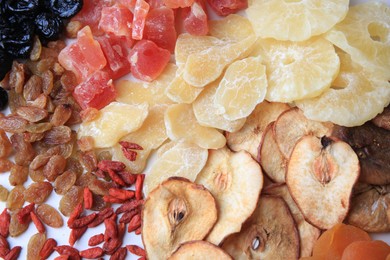 Photo of Different tasty dried fruits on white background, top view