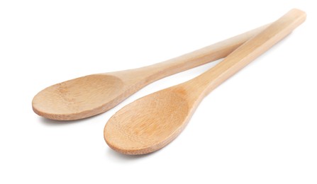 Two new wooden spoons on white background