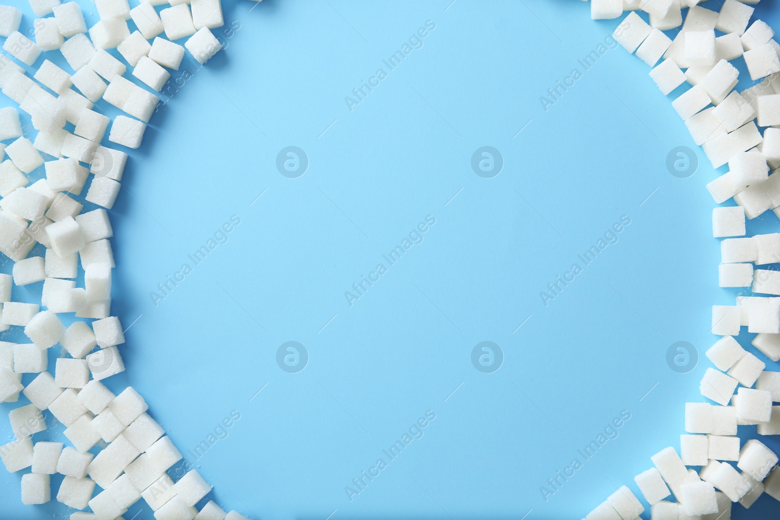 Photo of Frame of refined sugar cubes on color background, top view