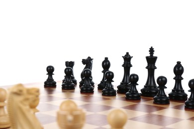 Set of black chess pieces on wooden board against white background