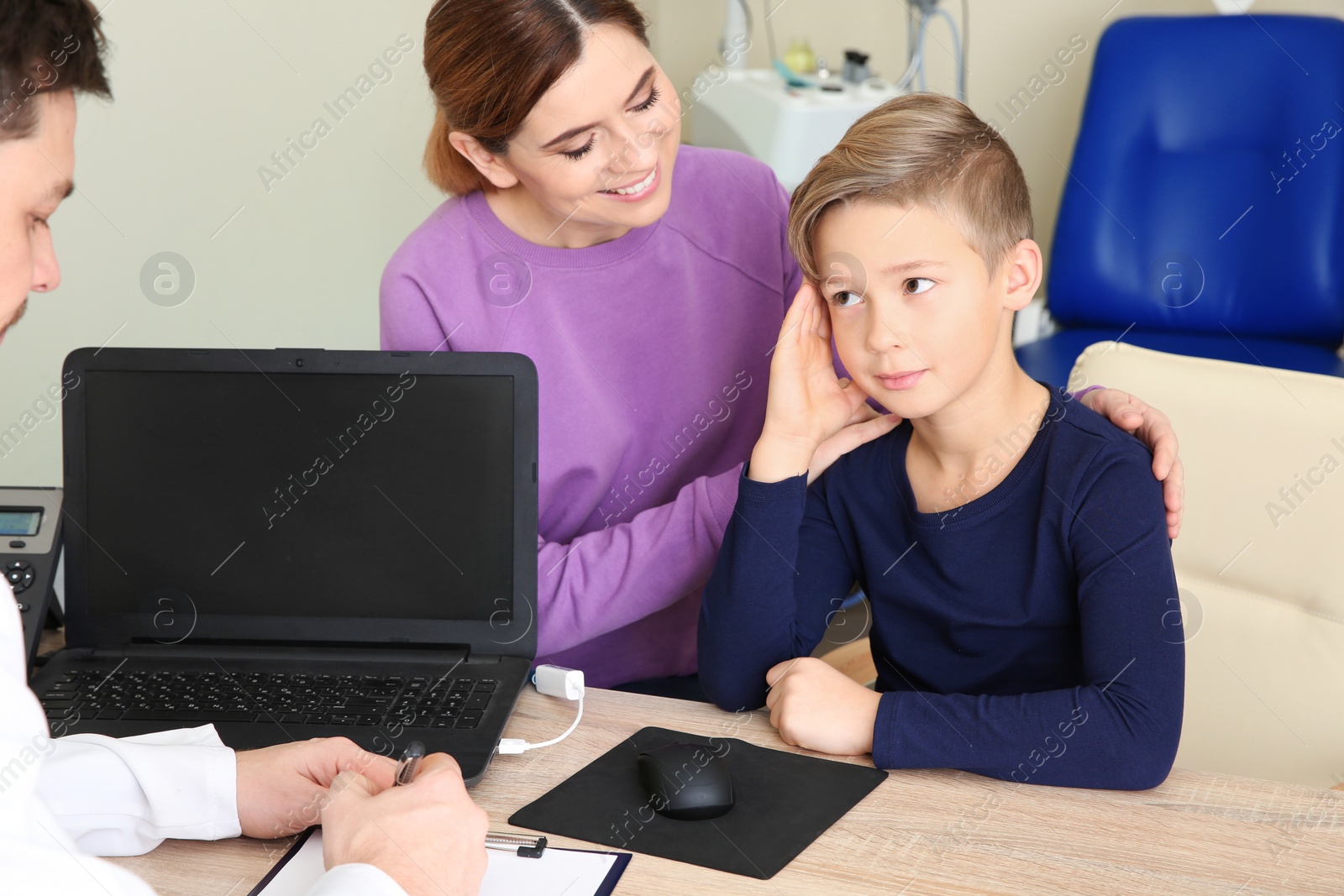 Photo of Woman with her child visiting doctor in hospital. Space for text