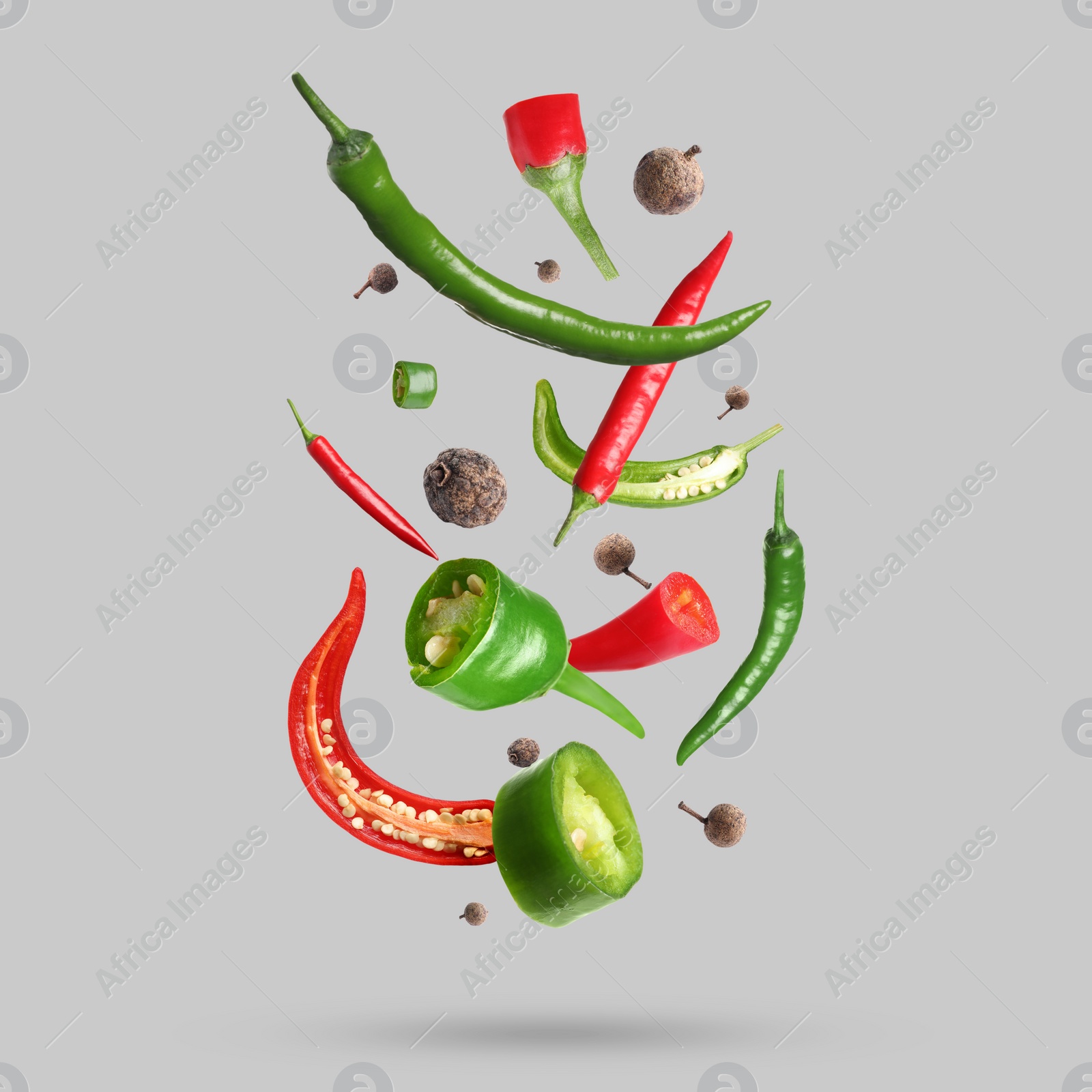 Image of Different spices falling on light grey background