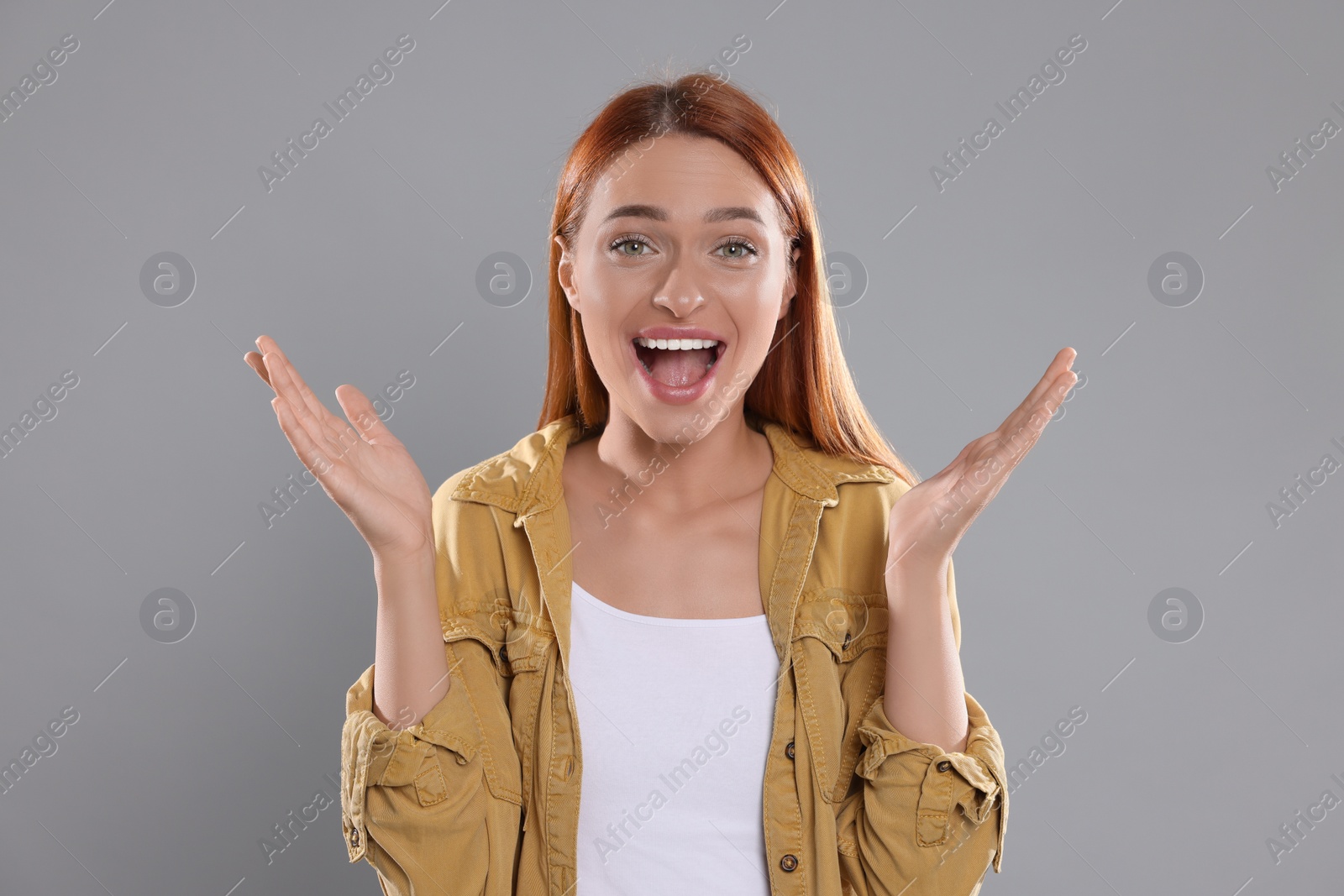 Photo of Casting call. Emotional woman performing on grey background