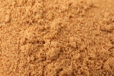 Photo of Brown coconut sugar as background, closeup view