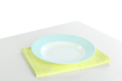 Photo of Empty plate and napkin on light table