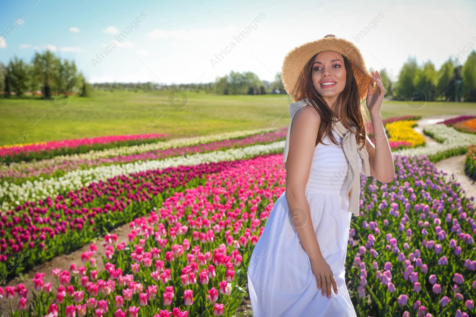 Photo of Woman in beautiful tulip field on sunny day