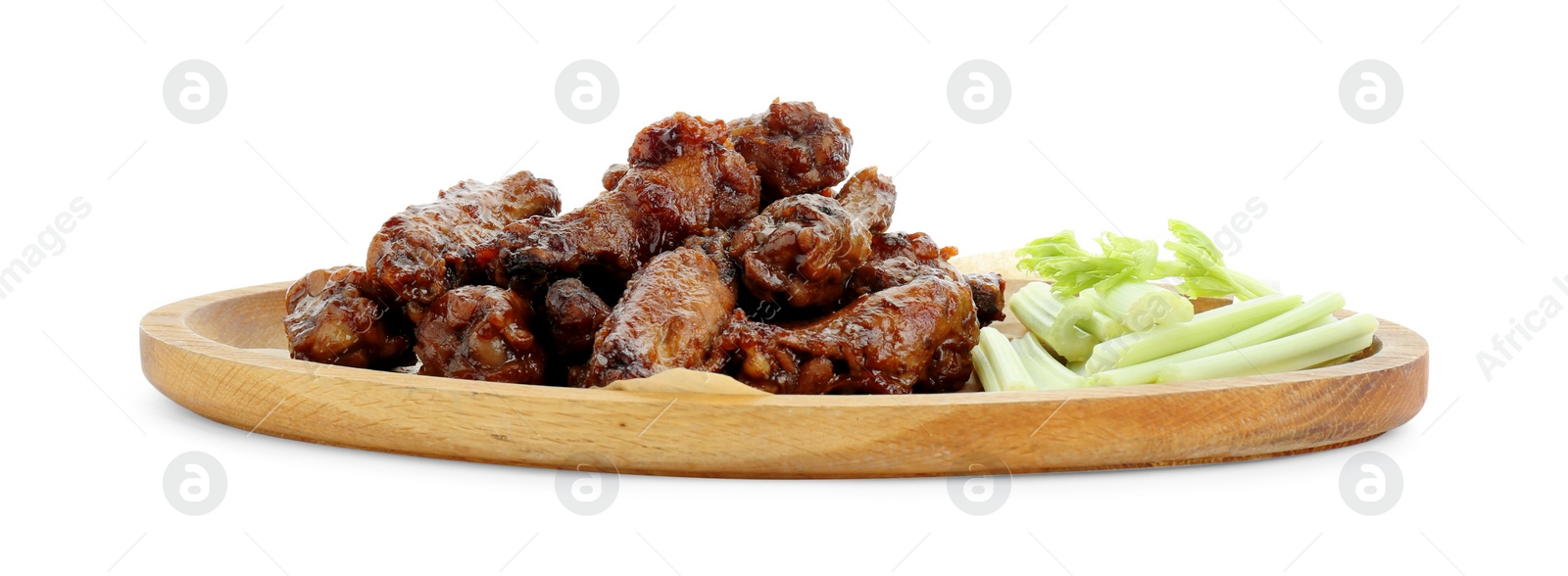 Photo of Wooden plate with delicious chicken wings and cut celery stalks isolated on white