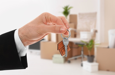 Image of Man with key in new modern apartment, closeup