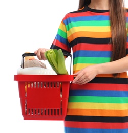 Photo of Young woman with shopping basket full of products isolated on white, closeup