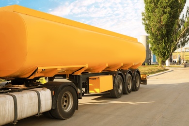 Photo of Modern yellow truck parked on country road