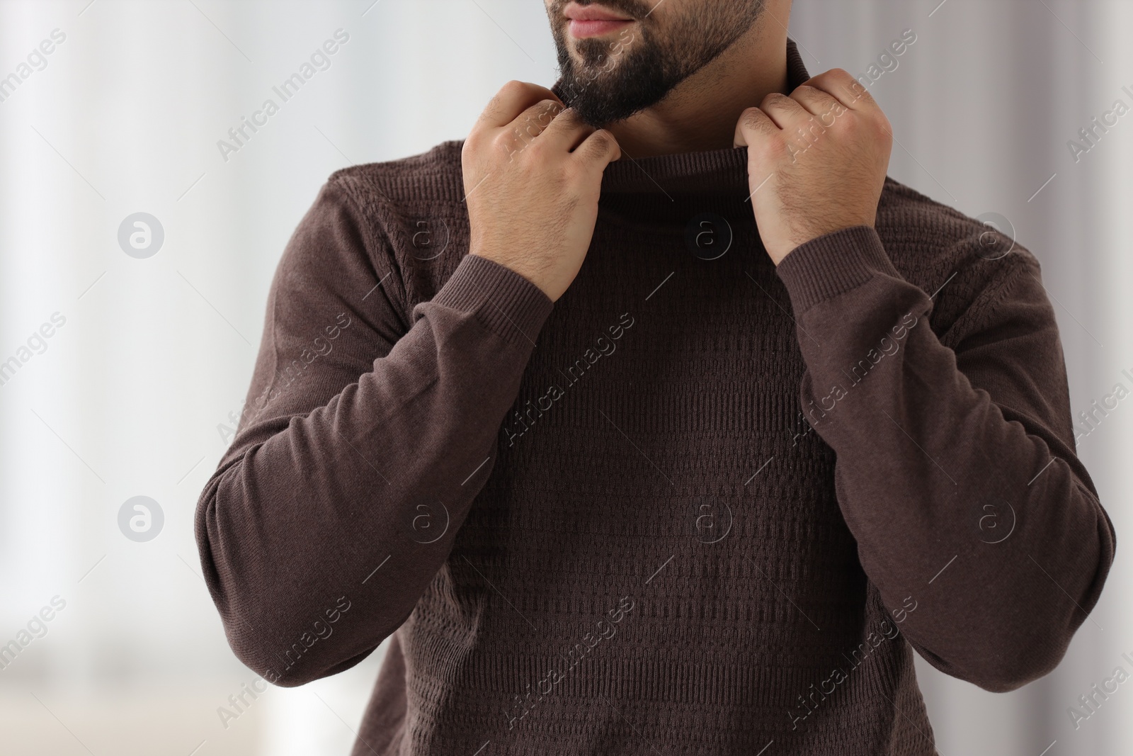 Photo of Man in stylish sweater against blurred background, closeup