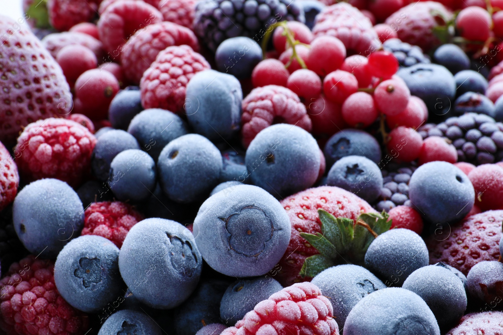 Photo of Mix of different frozen tasty berries as background, closeup