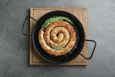Photo of Tasty homemade sausages with spices on grey table, top view