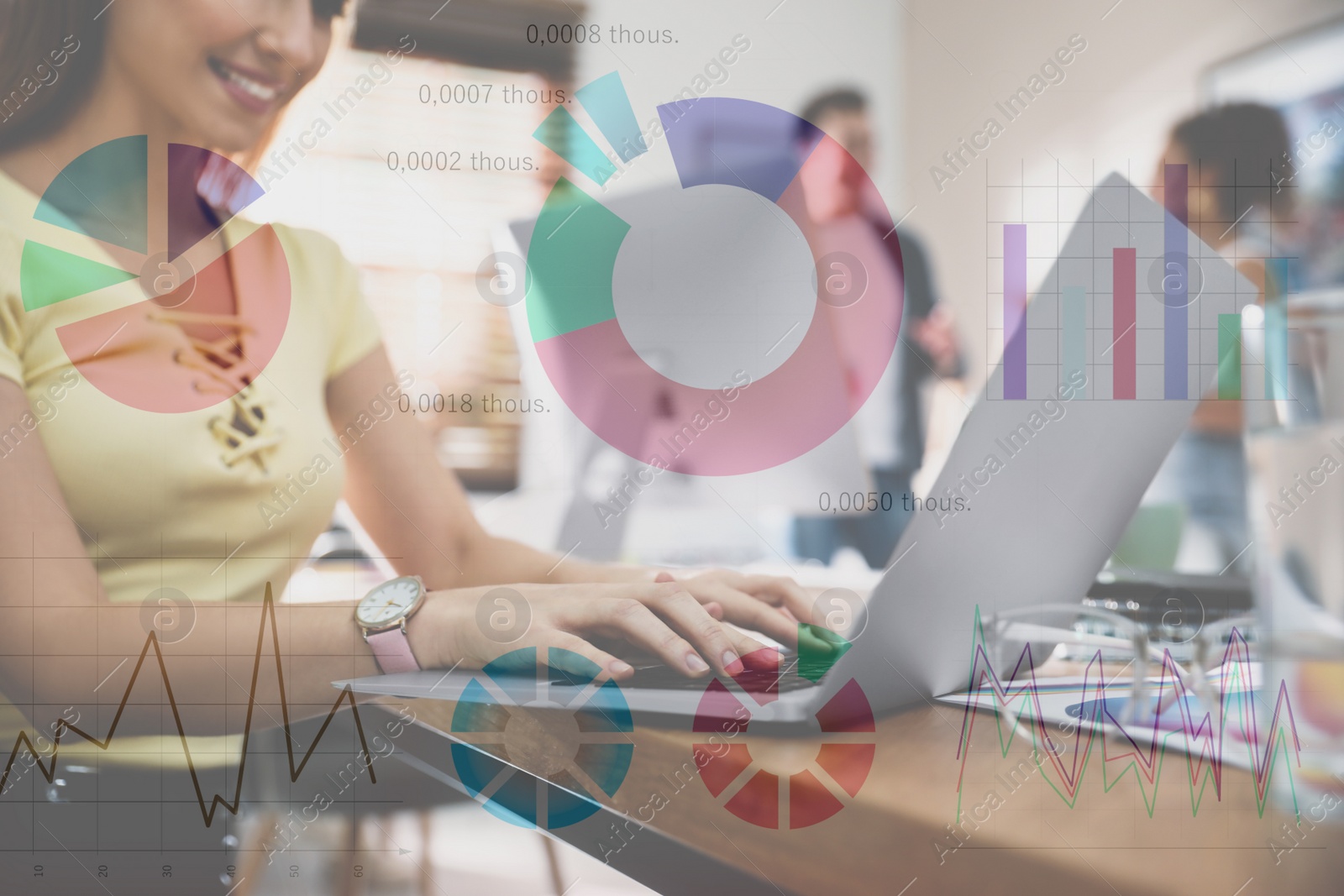 Image of Female designer working with laptop at table and illustration of colorful graphs. Double exposure