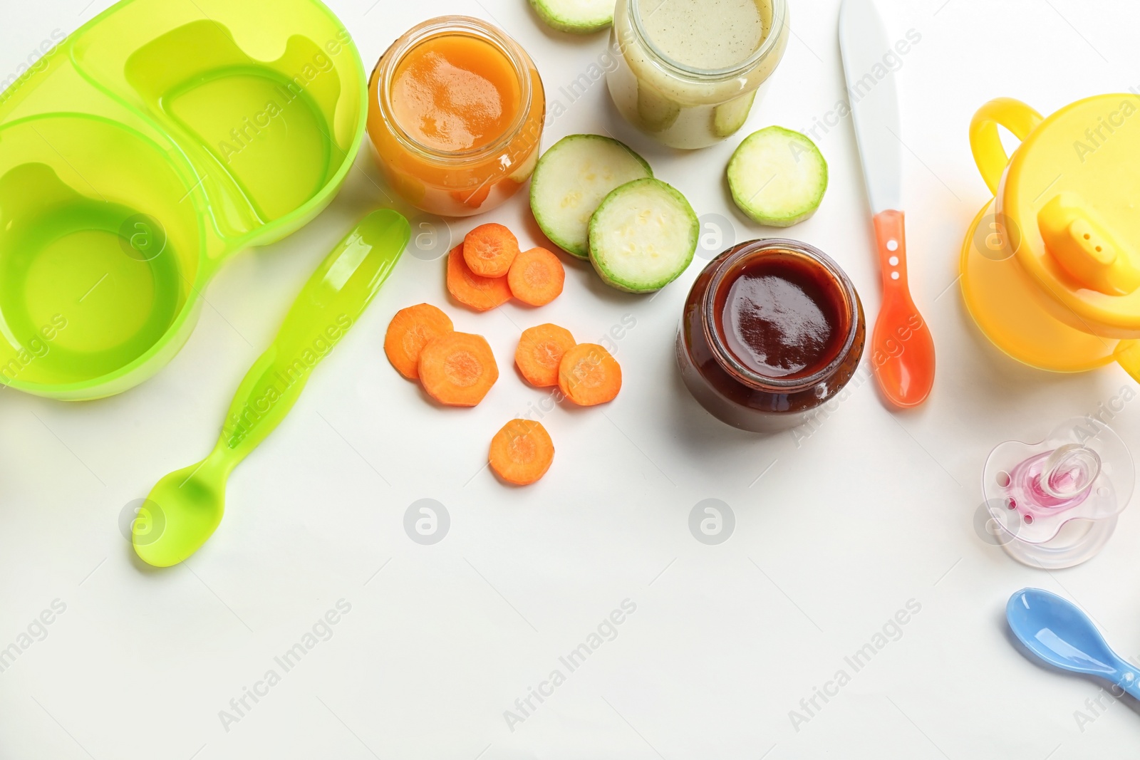 Photo of Flat lay composition with baby food, ingredients and accessories on light background