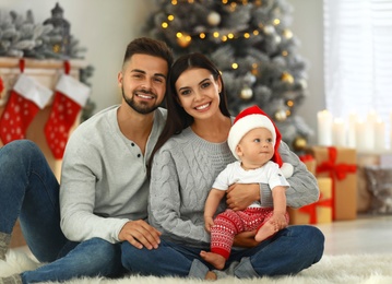 Photo of Happy family with cute baby at home. Christmas celebration