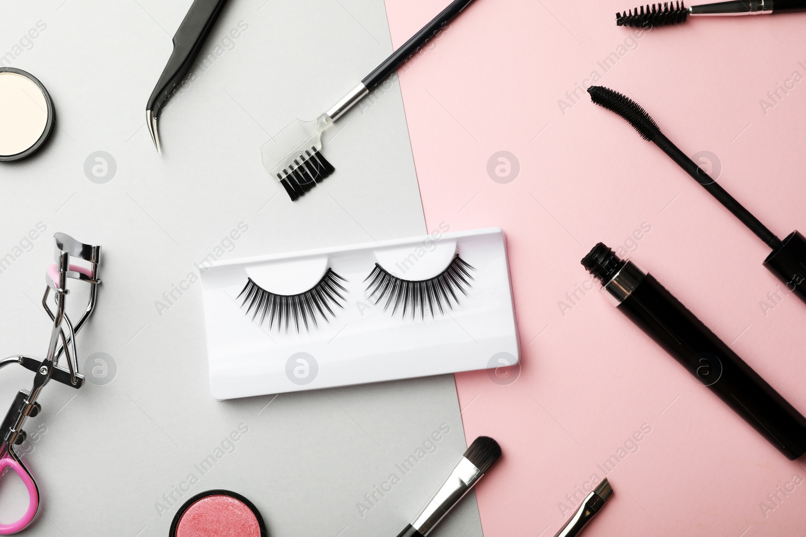 Photo of Flat lay composition with artificial eyelashes and accessories on color background