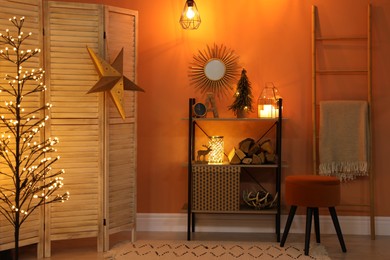 Photo of Beautiful room interior with Christmas decor on shelving unit