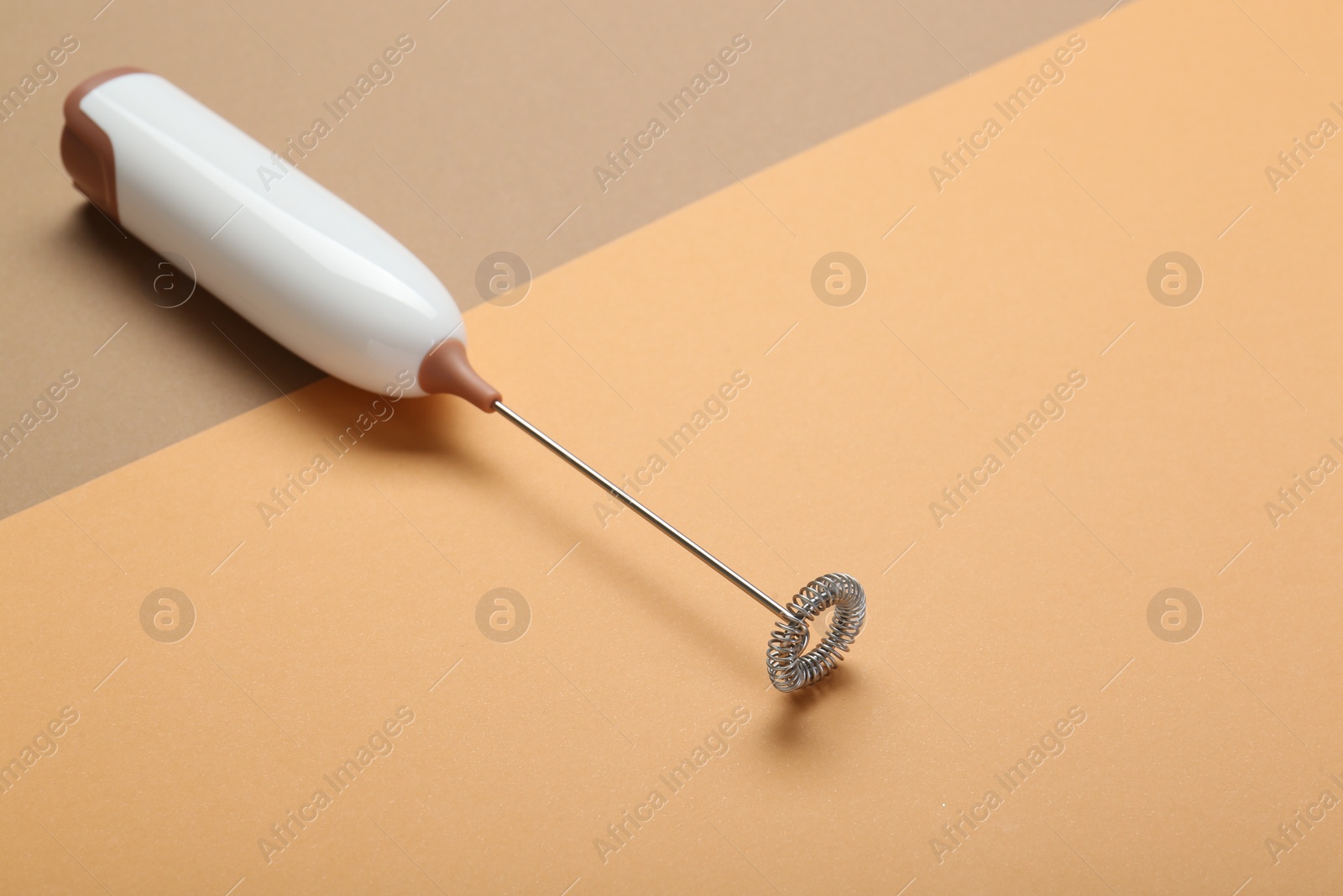 Photo of White milk frother wand on color background, space for text