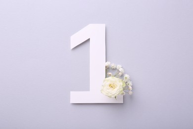 Photo of Paper number 1 and beautiful flowers on light grey background, top view