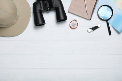 Photo of Flat lay composition with different safari accessories on white wooden background, space for text