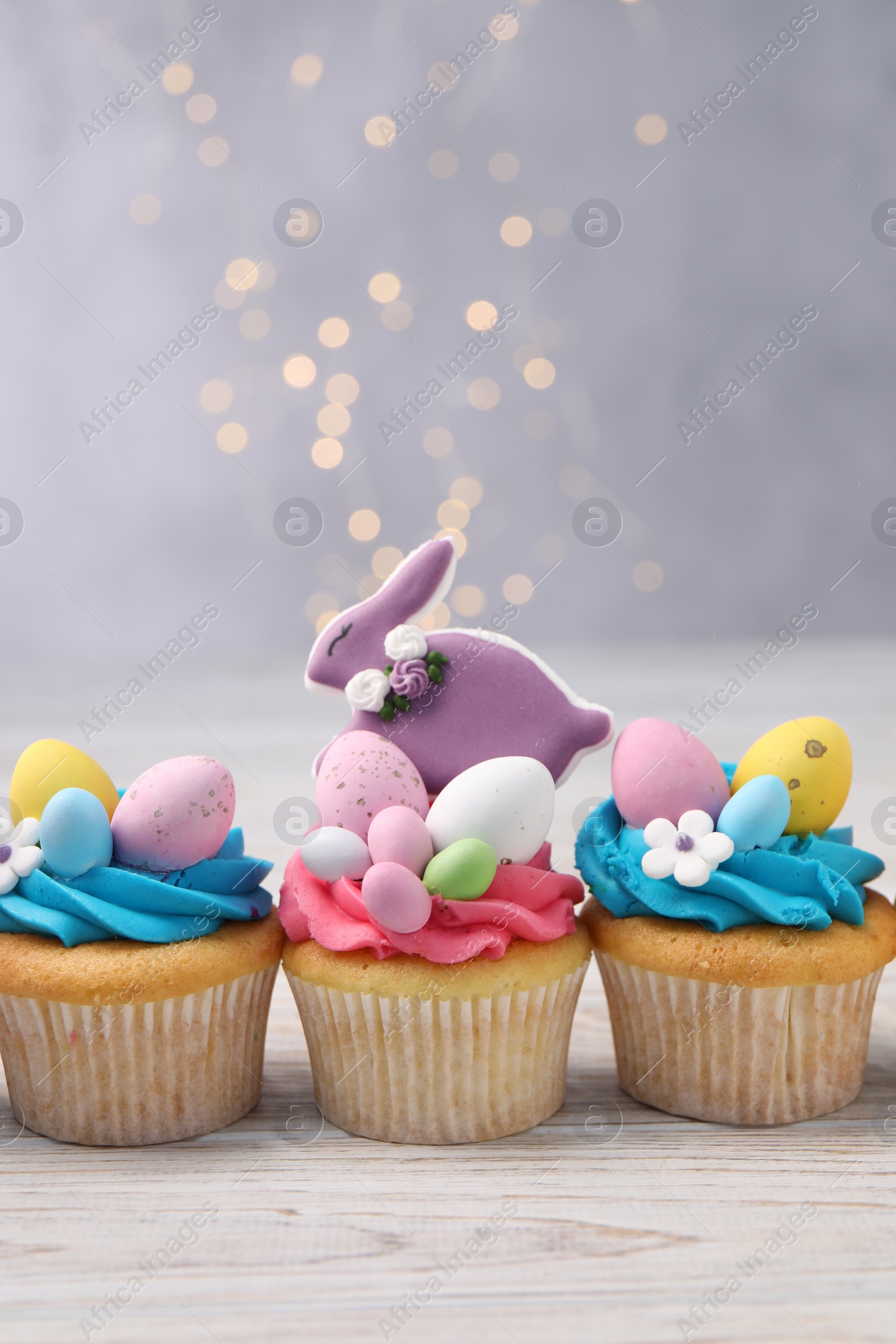 Photo of Tasty decorated Easter cupcakes on wooden table