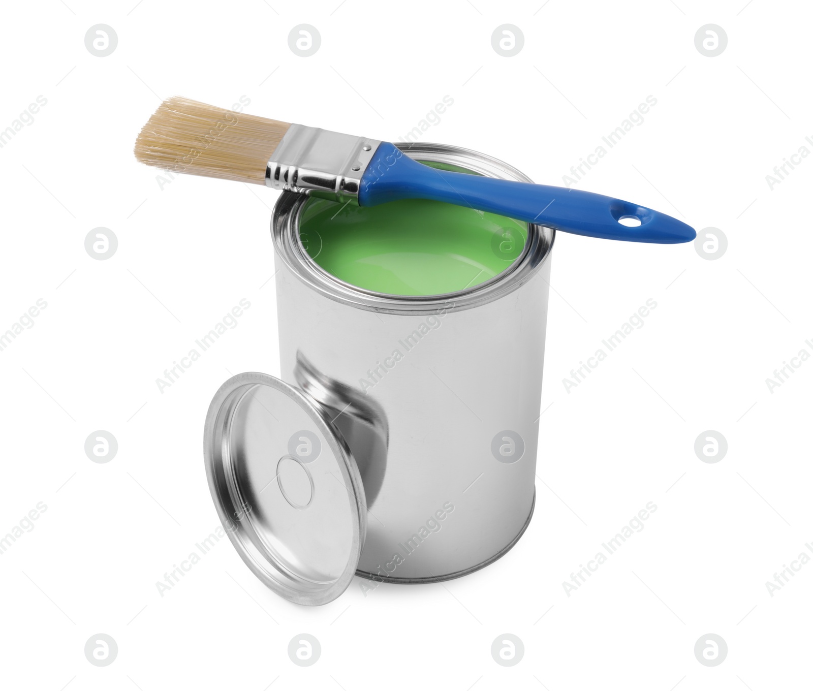 Photo of Can of light green paint and brush on white background