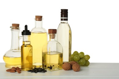 Photo of Vegetable fats. Different cooking oils and ingredients on wooden table against white background