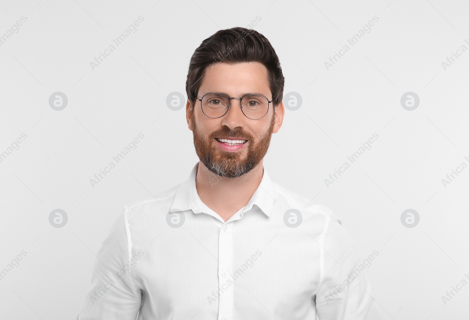 Photo of Portrait of handsome man in glasses on white background