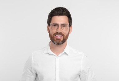 Photo of Portrait of handsome man in glasses on white background