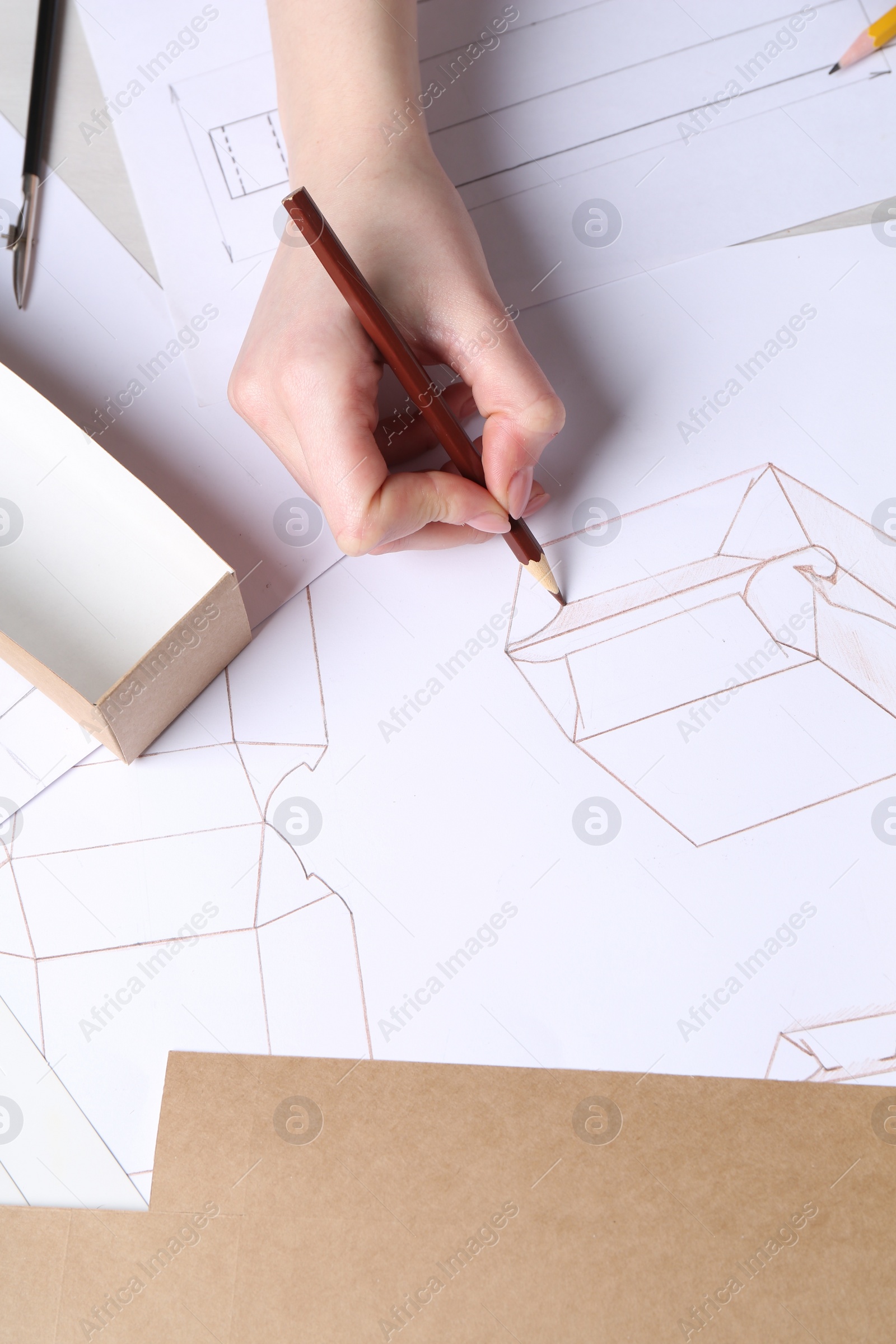 Photo of Woman creating packaging design at table, top view