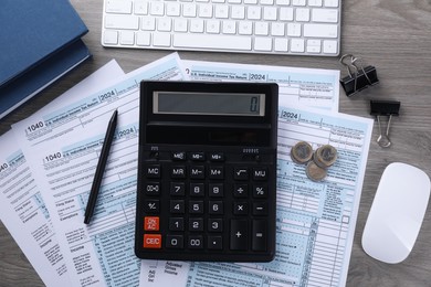 Photo of Tax accounting. Flat lay composition with calculator and documents on wooden table