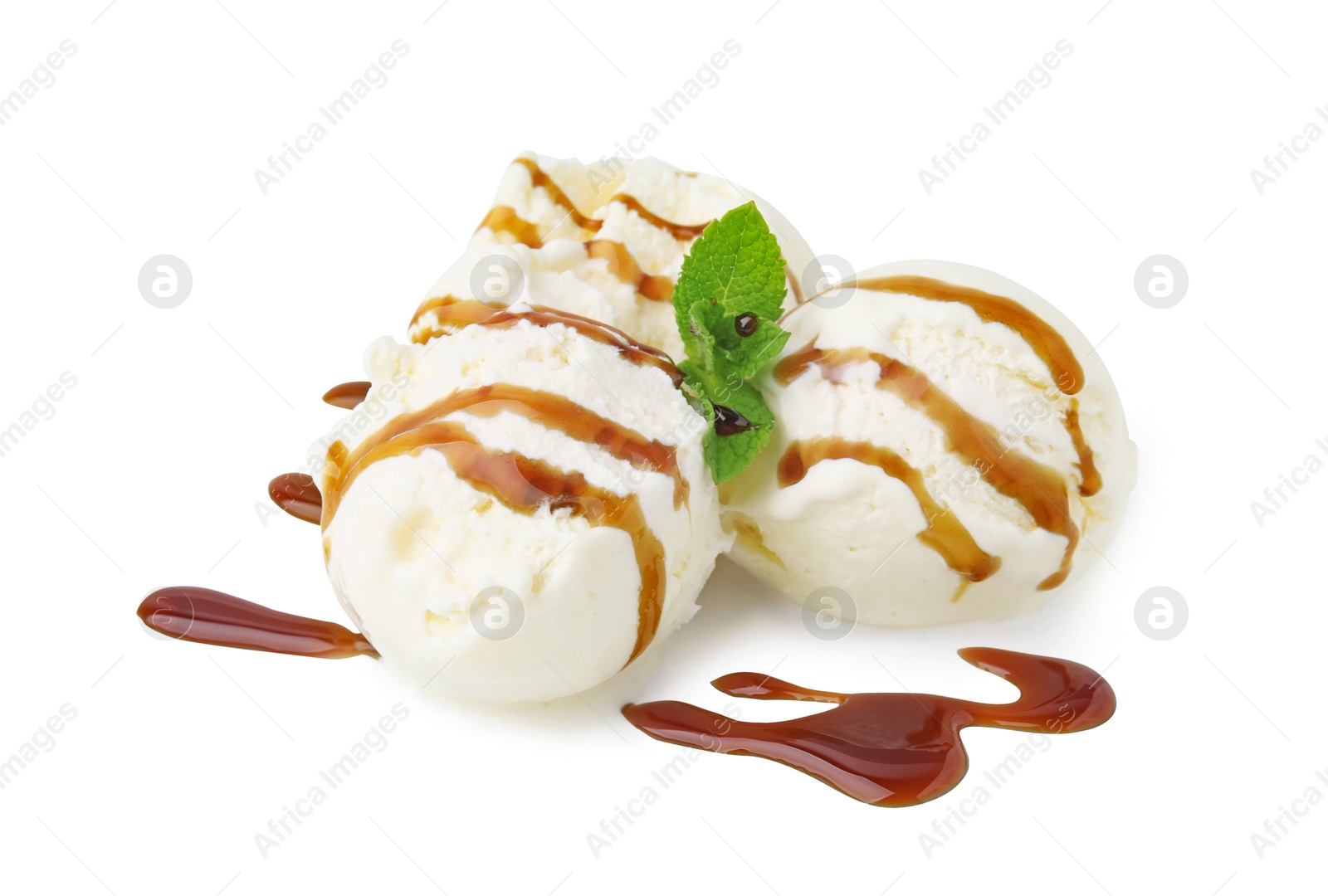 Photo of Scoops of ice cream with caramel sauce and mint isolated on white