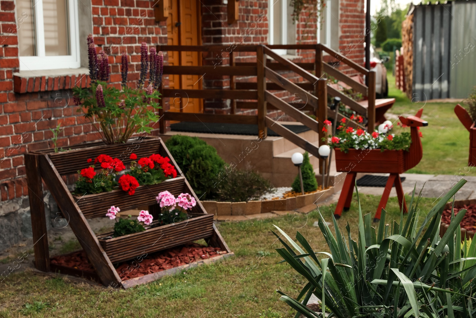 Photo of Beautiful backyard with blooming flowers and shrubs