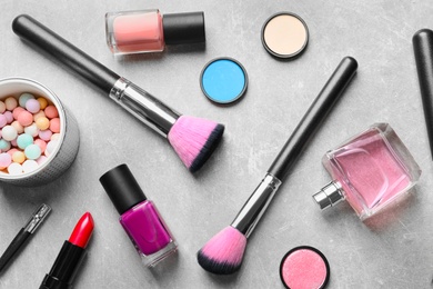 Photo of Flat lay composition with decorative cosmetics on gray background