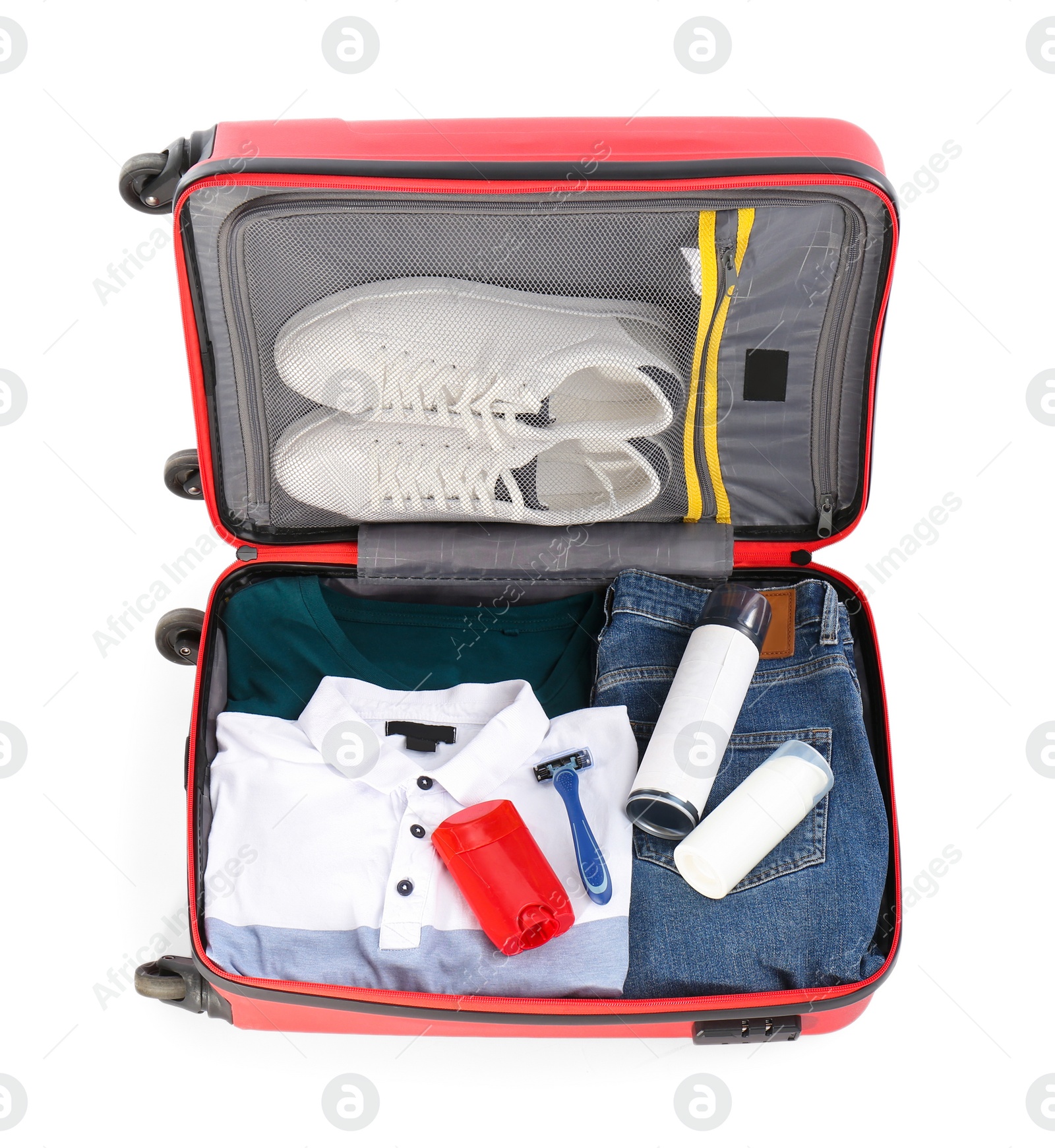 Photo of Packed suitcase with deodorants and clothes on white background