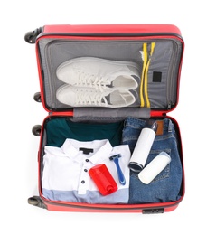 Photo of Packed suitcase with deodorants and clothes on white background