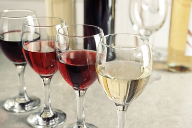 Elegant glasses with delicious wine on table