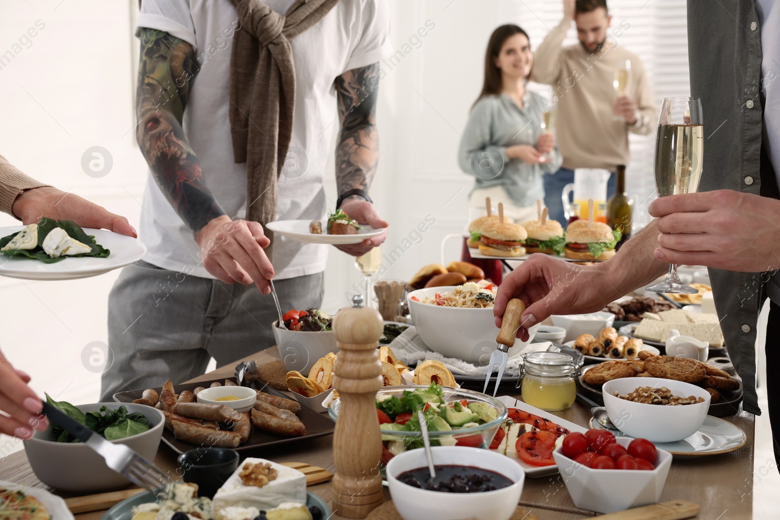 Photo of People near buffet table with food indoors, closeup. Brunch setting