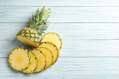 Photo of Flat lay composition with fresh sliced pineapple on wooden background