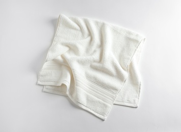 Photo of Clean soft terry towel on light background, top view