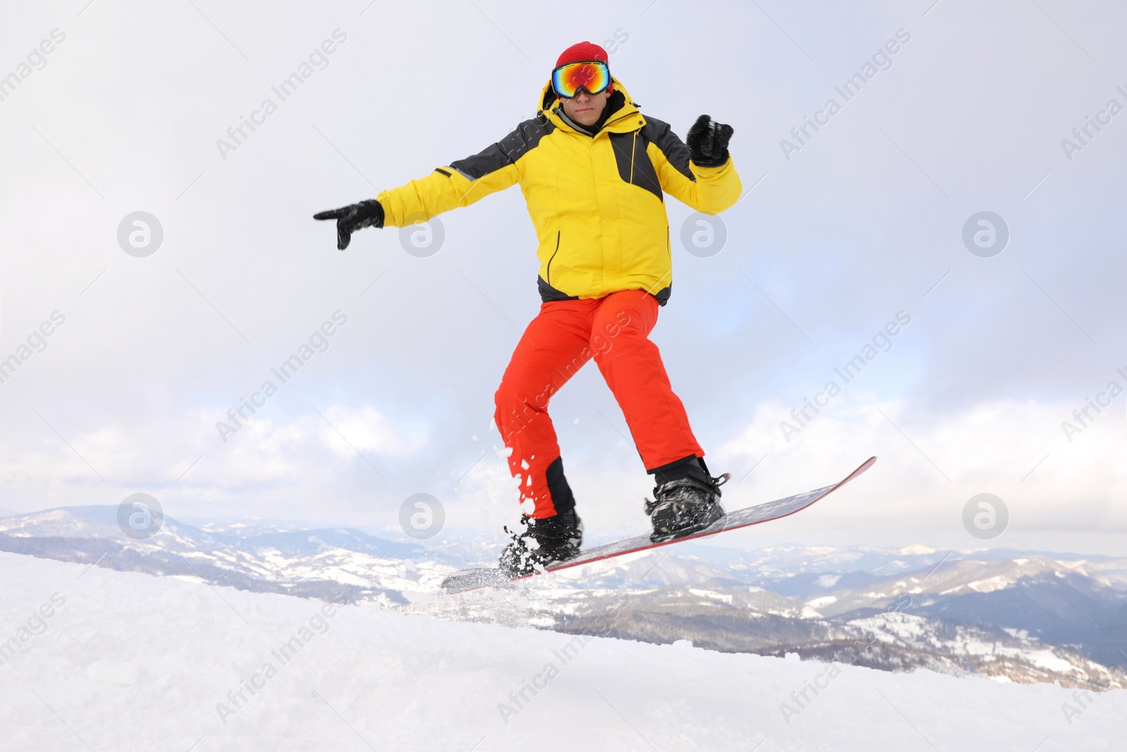 Photo of Male snowboarder on snowy hill. Winter vacation