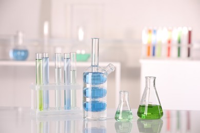 Laboratory analysis. Different glassware with liquids on white table indoors