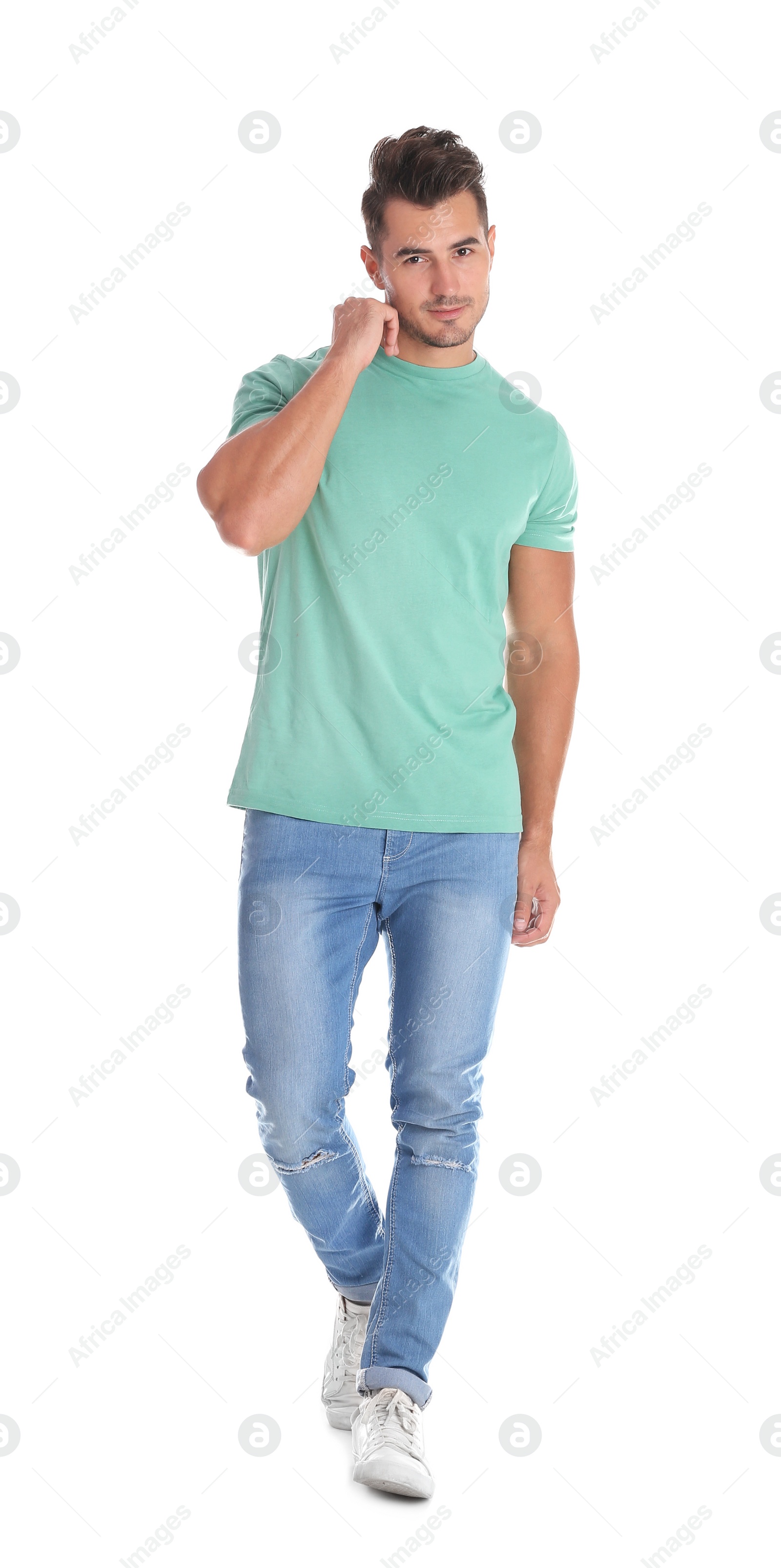 Photo of Young man in stylish jeans on white background