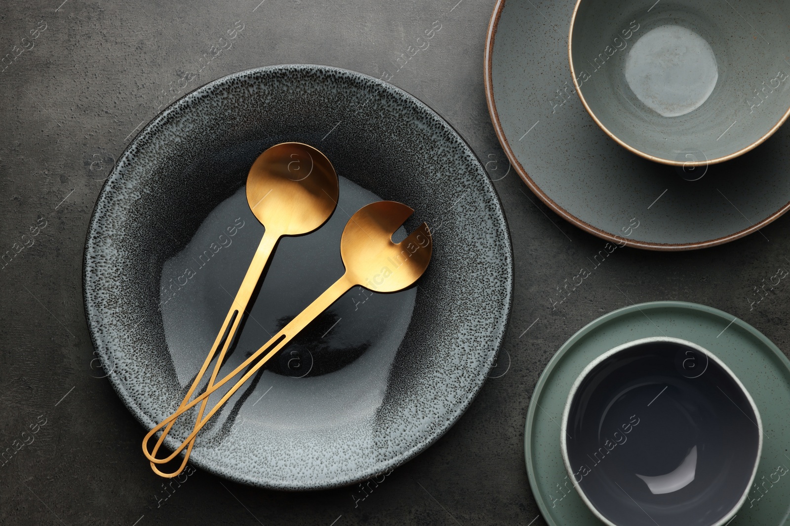 Photo of Stylish empty dishware and utensils on grey table, flat lay