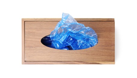 Photo of Blue medical shoe covers in wooden box isolated on white, top view