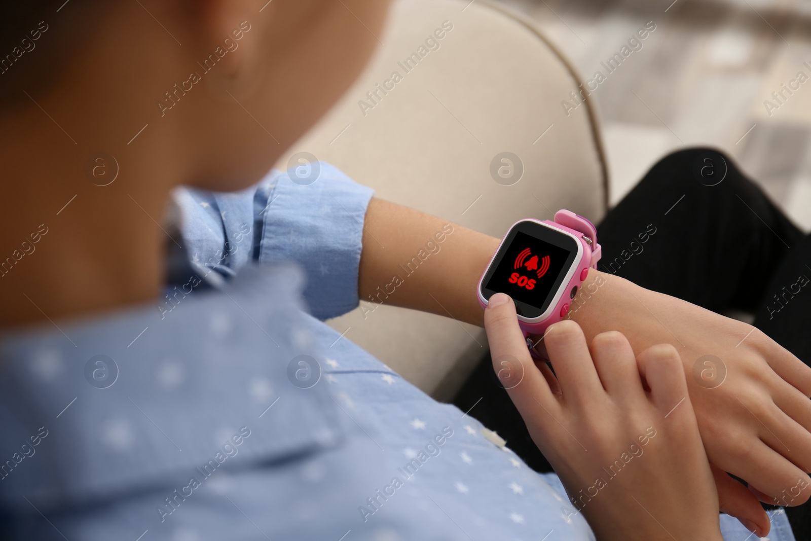 Image of Girl using SOS function on smartwatch indoors, closeup