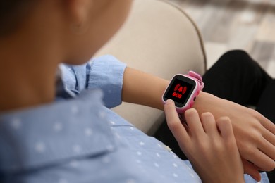 Image of Girl using SOS function on smartwatch indoors, closeup